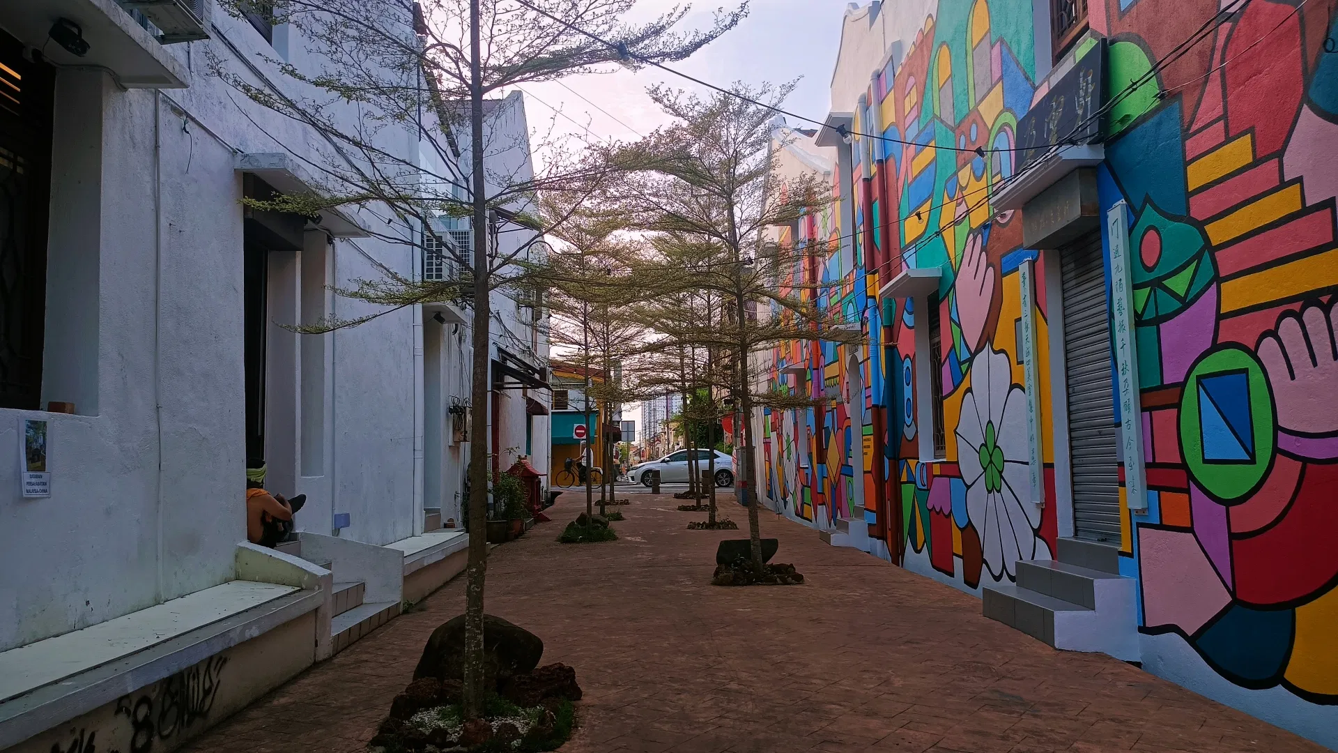 A lane of painted shophouse walls in Melaka's old town