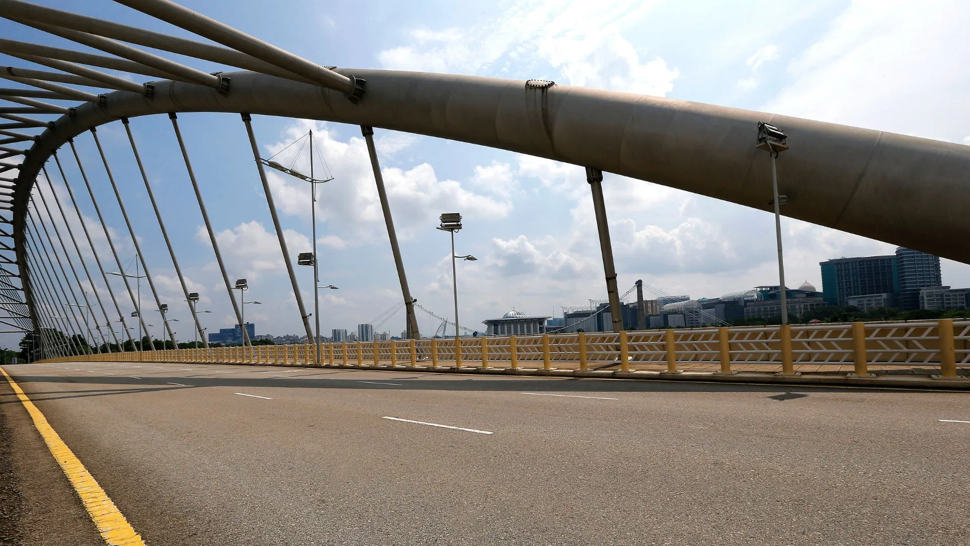 The roadway of an arched bridge over the lake in Putrajaya